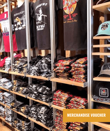 A well-stocked retail display of folded and hanging t-shirts and hats.