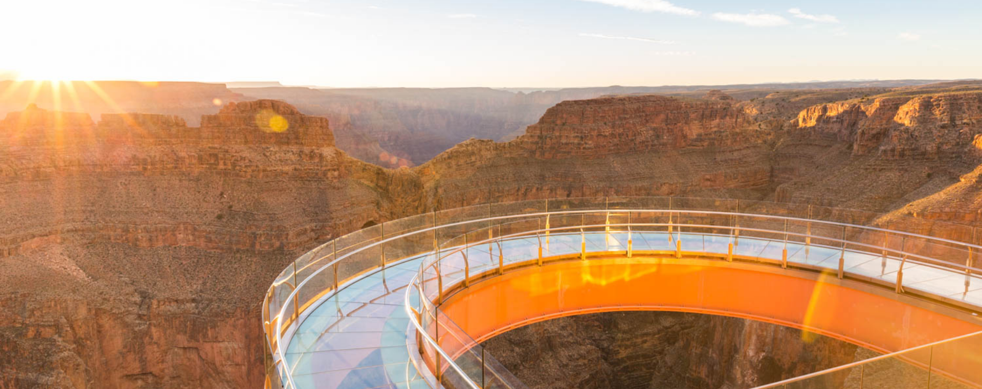 The Skywalk at Eagle Point, a 10-foot wide, horseshoe-shaped glass bridge extending 70 feet out over the rim of the Grand Canyon, is seen in the glow of sunset light.